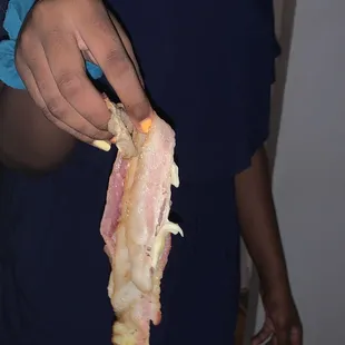 a woman holding a piece of bacon