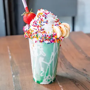 a milkshake with sprinkles and strawberries