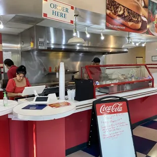 a woman ordering food at a fast food restaurant