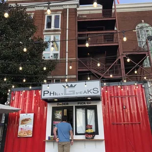 a man standing in front of a food truck