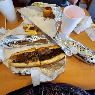 Two Originals, full sized, with cheese wiz, a gumbo full size, two orders of fries, and a small wrapped mushroom cheesesteak