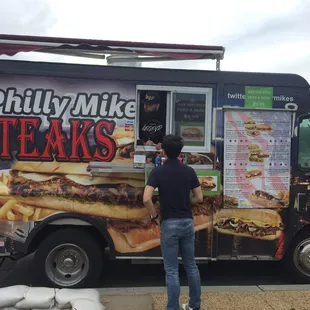 a man standing in front of a food truck