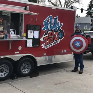 a man standing in front of a food truck