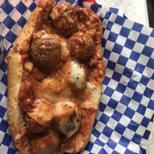 a pizza with meatballs and cheese