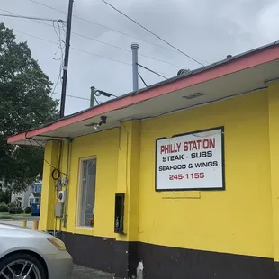 a yellow building with a sign for philly station
