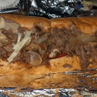 Steak sub w/ onions, mushroom, lettuce, tomatoes, and provolone. Good stuff.(Don&apos;t let it sit too long before you eat it)