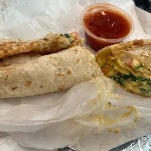 Egg, cheese, spinach and tomato in a wrap.