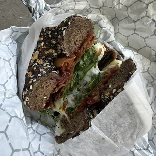 Pumpernickel everything bagel with egg, cheese, bacon and arugula.  Spicy mayo (yum) on the side