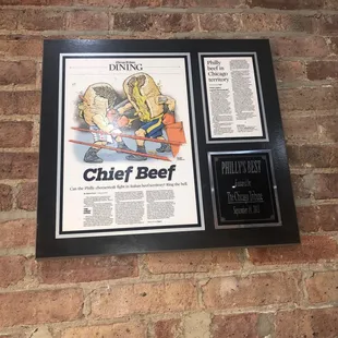 a brick wall with a framed advertisement