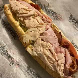 a sub sandwich with meat and cheese