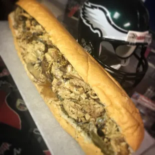 Our 12 hour marinated chicken cheesesteak with mushrooms, onions, and peppers.