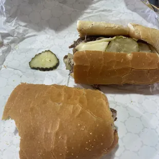 two sandwiches with pickles