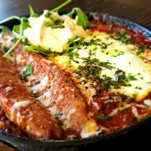 Our House Simmered Shakshuka with Spicy Sour Creme and your choice of egg and Protein with griddle toast for dipping. A Great Share plate!