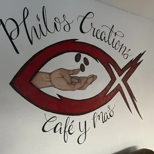 a hand holding a fish symbol