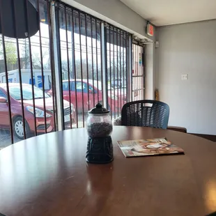 a table and chairs in front of a window
