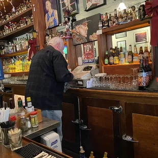 Old school cash register versus the electronic touch screens that most restaurants and bars use.