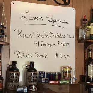 a whiteboard with a price list on it