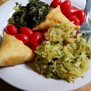 Delicious take-away Kenyan food: samosas, collards, cabbage. #organic tomato my own.