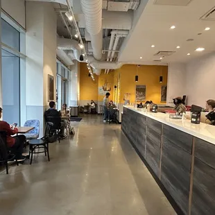 people sitting at tables in a coffee shop