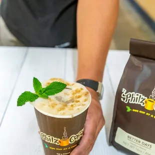 a person holding a cup of coffee