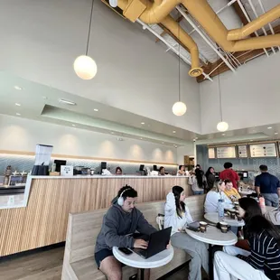 people sitting at tables in a coffee shop