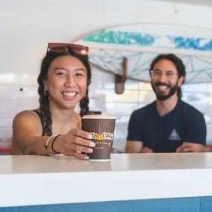 a woman holding a cup of coffee