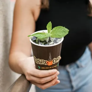 a woman holding a cup of coffee