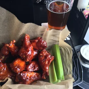 a basket of wings and celery