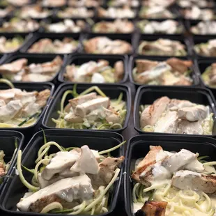 a tray of chicken and noodles