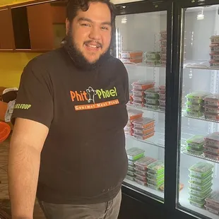 a man standing in front of a refrigerator
