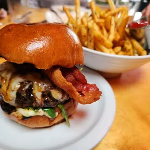 a burger with bacon, cheese, and lettuce