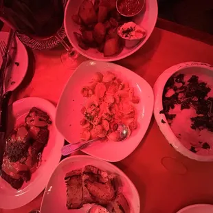 a table with plates of food and utensils