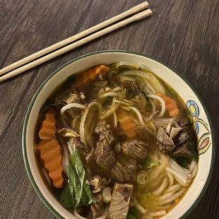 Pho Bo Kho: Vietnamese style spicy beef stew cooked with spices &amp; ground lemongrass, carrot &amp; onion sprinkled with scallion and cilantro.