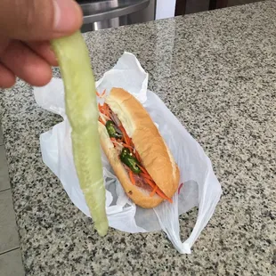 A1. Banh Mi Thit one long cucumber strand from the middle of the cucumber... I guess chopping cucumbers is too hard?? Disgusting and lazy