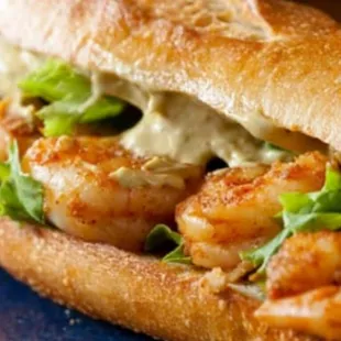 a shrimp sandwich with lettuce and mayo