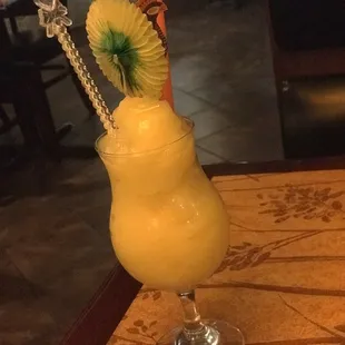 a glass with a drink on a table