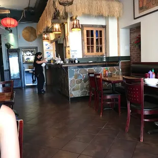 a woman sitting at a table in a restaurant