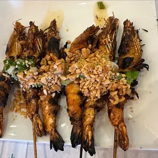 a plate of grilled grasshoppers