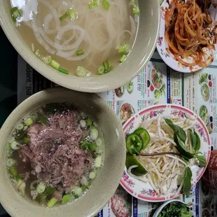 two bowls of pho with meat and noodles