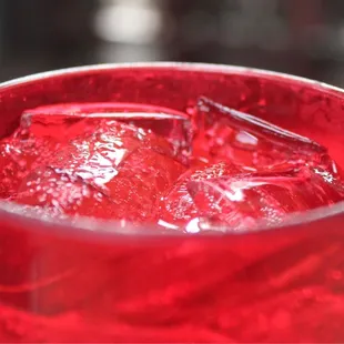 a closeup of a red drink in a glass