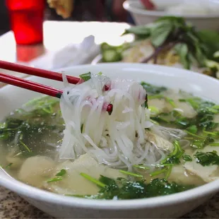 a bowl of soup and chopsticks