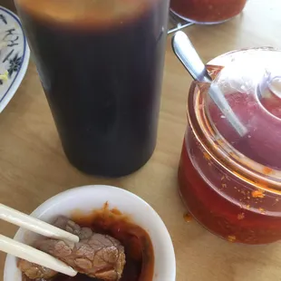 Lemon grass chili oil mixed with the pho plum sauce to dip the beef strips from the bowl of pho. Incredible.