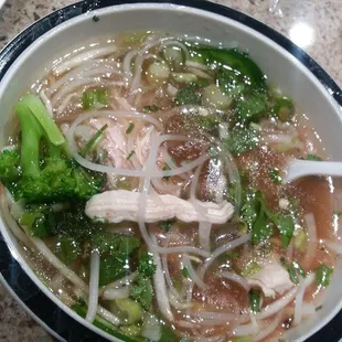 a bowl of soup with broccoli