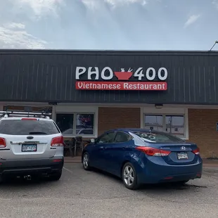 two cars parked in front of a restaurant