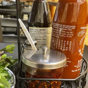 a plate of salad and a bottle of sauce