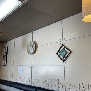 two clocks on the wall of a restaurant