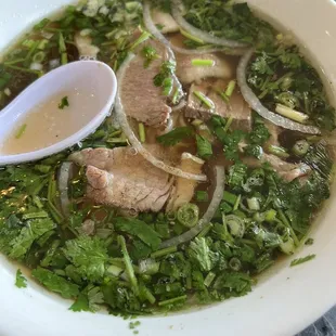 a bowl of soup with meat and vegetables