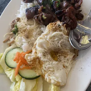 a plate of food with rice, meat, and vegetables