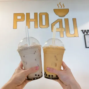 two people holding drinks in their hands