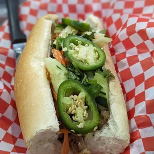 a hot dog with jalapenos and onions